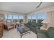 Bright living room with ocean views, sofa, chairs, coffee table and side tables with lamps at 627 Alhambra Rd # 601, Venice, FL 34285