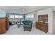 Cozy living room with large windows, ceiling fan, ample seating, stylish cabinets and water views at 627 Alhambra Rd # 601, Venice, FL 34285