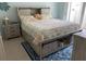 The bedroom features a bed with storage beneath it and blue accent rug at 634 Bird Bay E Dr # 103, Venice, FL 34285