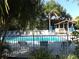 A clear view of the community pool with an adjacent picnic shelter and lounge chairs at 634 Bird Bay E Dr # 103, Venice, FL 34285
