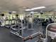 Well-equipped gym featuring treadmills, weight machines, and mirrored walls for a complete fitness experience at 634 Bird Bay E Dr # 103, Venice, FL 34285