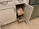 Kitchen cabinets with convenient pull out wooden shelving at 634 Bird Bay E Dr # 103, Venice, FL 34285