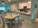 The kitchen features white cabinets, stainless steel appliances, and modern counters at 634 Bird Bay E Dr # 103, Venice, FL 34285