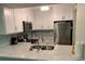 Renovated kitchen with stainless steel appliances, granite countertops, and ample storage at 634 Bird Bay E Dr # 103, Venice, FL 34285