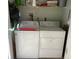 Bright and efficient laundry room with washer and dryer hookups and overhead storage at 634 Bird Bay E Dr # 103, Venice, FL 34285