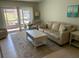 Inviting living room with a sliding glass door for outdoor access and ample seating at 634 Bird Bay E Dr # 103, Venice, FL 34285