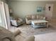 Cozy living room with a comfortable sofa, armchair, and beach-themed decor at 634 Bird Bay E Dr # 103, Venice, FL 34285