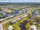 Aerial view of a waterfront community with canals, lush landscaping, and beautiful homes at 6627 Marius Rd, North Port, FL 34287