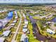 Aerial view of a waterfront home with pool, canal access, and lush landscaping at 6627 Marius Rd, North Port, FL 34287