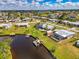 Scenic aerial shot of waterfront homes featuring private docks, boats, fire pit, and screened-in pools at 6627 Marius Rd, North Port, FL 34287