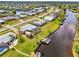 Aerial view of a waterfront home with shed, dock, canal access, and lush landscaping at 6627 Marius Rd, North Port, FL 34287