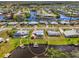 Aerial view of a waterfront home with pool, canal access, and lush landscaping at 6627 Marius Rd, North Port, FL 34287