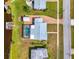 Aerial view of a house featuring a screened-in pool, firepit, personal dock, and brick driveway at 6627 Marius Rd, North Port, FL 34287