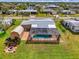 A perfect backyard featuring a screened-in pool, a storage shed, and a cozy brick fire pit at 6627 Marius Rd, North Port, FL 34287