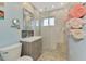 Modern bathroom featuring a glass shower, vanity with drawers, and updated fixtures at 6627 Marius Rd, North Port, FL 34287