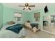 Cozy guest bedroom with two twin beds, neutral paint, and dual windows for ample natural light at 6627 Marius Rd, North Port, FL 34287