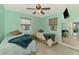 Shared bedroom with two beds, light gray flooring, and a large mirror at 6627 Marius Rd, North Port, FL 34287