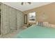 Bright bedroom showcasing coastal decor with an anchor accent and a serene window view at 6627 Marius Rd, North Port, FL 34287