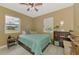 Comfortable bedroom featuring a queen bed, light gray flooring, and window views at 6627 Marius Rd, North Port, FL 34287