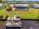 Waterfront home featuring a private dock with a boat, screen enclosed pool, and outdoor fire pit at 6627 Marius Rd, North Port, FL 34287