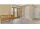 Bright foyer features tile floors, decorative glass front door, and a charming wooden bench at 6627 Marius Rd, North Port, FL 34287