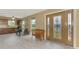 Inviting foyer with a decorative glass front door, wood bench, and a view of the kitchen at 6627 Marius Rd, North Port, FL 34287