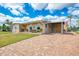 Charming single-story home featuring a brick driveway and covered carport, with water access and canal views at 6627 Marius Rd, North Port, FL 34287