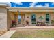 Welcoming front porch with decorative plants and seating area at 6627 Marius Rd, North Port, FL 34287