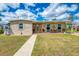 Charming single-story home with a well-maintained lawn and inviting front porch at 6627 Marius Rd, North Port, FL 34287