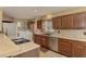Updated kitchen featuring stainless steel appliances, stylish backsplash, and a convenient laundry area at 6627 Marius Rd, North Port, FL 34287