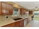 This is a close up of the kitchen and it features dark cabinetry, stainless steel appliances, and a stylish backsplash at 6627 Marius Rd, North Port, FL 34287