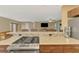 View of the breakfast bar which features a stone accent wall and view to the living area at 6627 Marius Rd, North Port, FL 34287