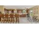 Open concept kitchen features dark wood cabinetry, mosaic backsplash, and breakfast bar with seating at 6627 Marius Rd, North Port, FL 34287