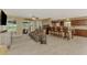 Living room features tile floors, sliders to outdoor patio, and is open to the kitchen and bar at 6627 Marius Rd, North Port, FL 34287