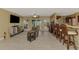 Inviting open-concept living area with tile floors, ceiling fan, and direct access to the pool at 6627 Marius Rd, North Port, FL 34287
