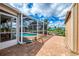 Brick patio offers a transition to the pool, outdoor storage and waterfront views at 6627 Marius Rd, North Port, FL 34287