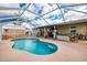 Enjoy the enclosed pool, hot tub, outdoor storage, and lounge area for relaxing and entertaining at 6627 Marius Rd, North Port, FL 34287