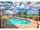 Enjoy the screened-in pool and canal views, with a large jar adding a decorative touch at 6627 Marius Rd, North Port, FL 34287