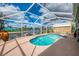 Screened-in pool offers a refreshing escape with beautiful water views and an outdoor shed at 6627 Marius Rd, North Port, FL 34287