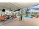 Outdoor area featuring a pool with views of the waterway, a covered patio, and seating at 6627 Marius Rd, North Port, FL 34287