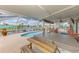 Relaxing screened-in pool area with a hot tub and seating, overlooking a scenic waterfront canal at 6627 Marius Rd, North Port, FL 34287