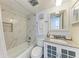 Bathroom with marble tile, modern fixtures, a shower-tub combo, and a granite countertop vanity at 110 Vista Hermosa Cir # 102B, Sarasota, FL 34242