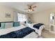 Cozy guest bedroom with two twin beds, nautical decor, and plenty of natural light at 110 Vista Hermosa Cir # 102B, Sarasota, FL 34242