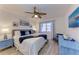 Main bedroom featuring king-sized bed, coastal decor, and plenty of natural light at 110 Vista Hermosa Cir # 102B, Sarasota, FL 34242