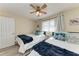 Guest bedroom featuring two beds, coastal decor, and a ceiling fan at 110 Vista Hermosa Cir # 102B, Sarasota, FL 34242