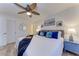 Stylishly decorated bedroom with nautical accents, a ceiling fan, and a blue nightstand at 110 Vista Hermosa Cir # 102B, Sarasota, FL 34242