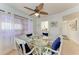 Bright dining area featuring a glass table, seating for four, and natural lighting at 110 Vista Hermosa Cir # 102B, Sarasota, FL 34242