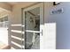 Bright condo entrance with a storm door and unit number 102B at 110 Vista Hermosa Cir # 102B, Sarasota, FL 34242