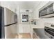 Updated kitchen featuring stainless steel appliances and a convenient pass-through window at 110 Vista Hermosa Cir # 102B, Sarasota, FL 34242