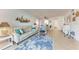 Well-lit living room with a sofa, chairs, and adjacent dining area; coastal decor at 110 Vista Hermosa Cir # 102B, Sarasota, FL 34242